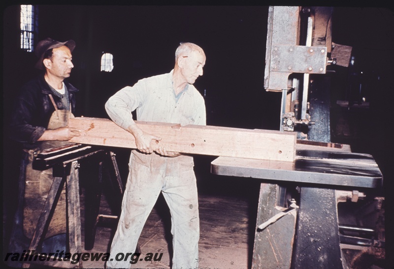 T04324
Workers feeding timber through a bandsaw, Midland Workshops
