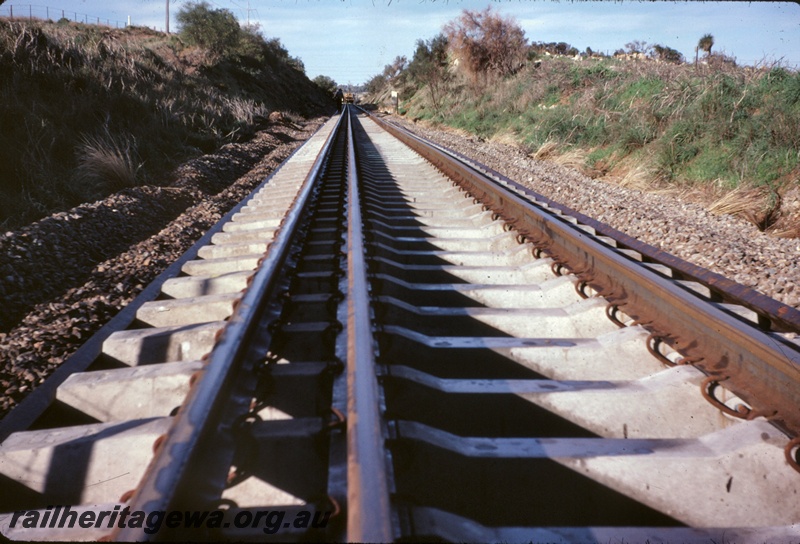 T05019
Renewal of dual gauge track, track machine, worker, Cockburn South, Kalgoorlie to Kwinana Rehabilitation Project, track level view
