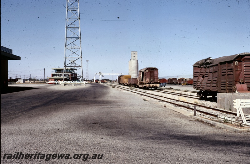 T05353
Damaged standard gauge wagons, other wagons, sidings, yard master's office, light towers, silos, gantry, buffer, West Merredin yard, EGR line, ground level view
