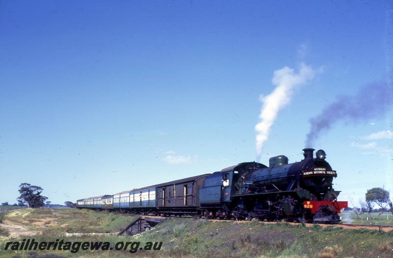 T05413
W class 928 on Australian Railway Historical Society Western Australian Division tour train to Greenhills, crossing culvert, YB line, side and front view from ground level
