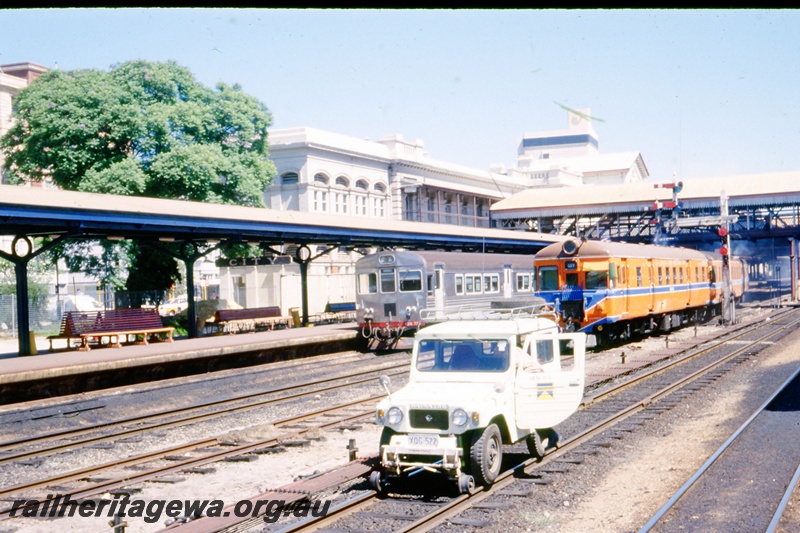 T05521
Hi Rail vehicle  Perth station. ADG and ADB railcard in background. ER line.
