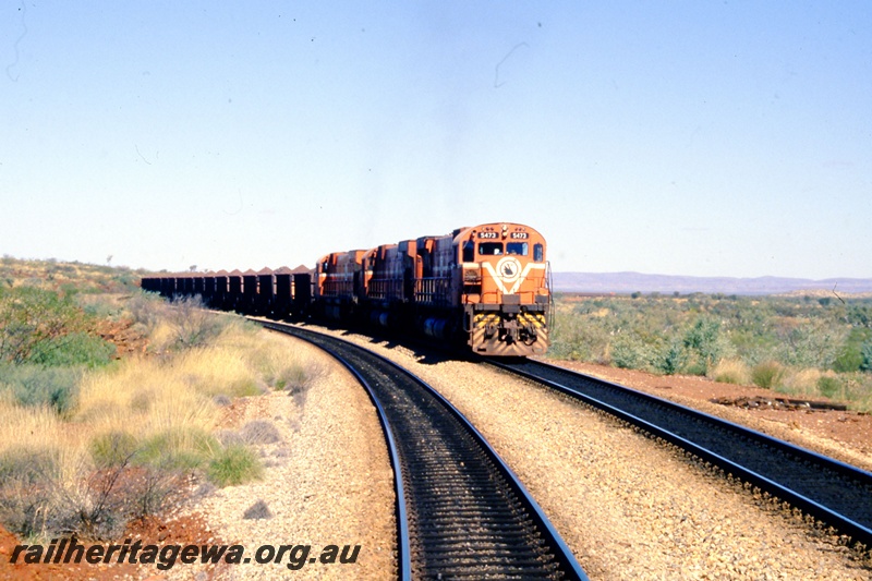 T05529
Mt Newman Mining's ALCO_MLW 5473 heads a loaded iron ore train near Port Hedland. 
