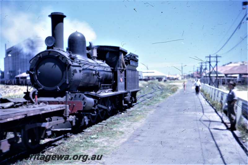T05611
G class shunting Bunbury,shunters float in front of locomotive. Wheat silo in background. SWR line.
