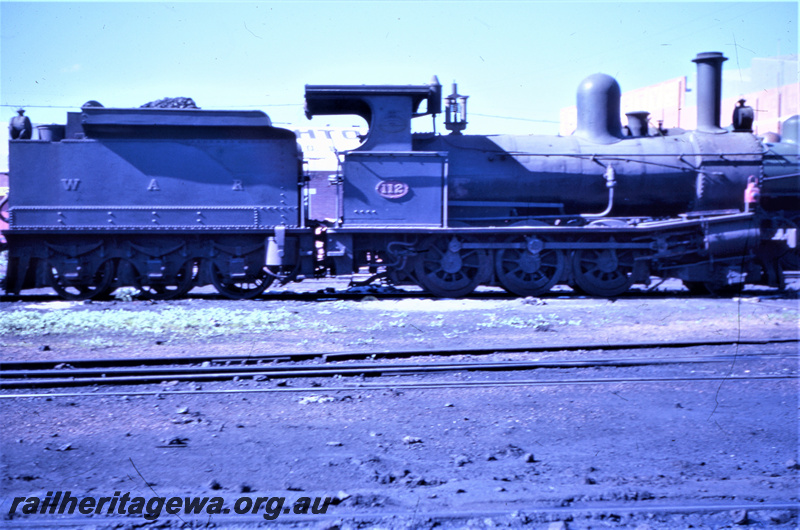 T05612
G class 118 at Fremantle locomotive depot. Side view of locomotive. The letters W.A.R. on side of tender. ER line.
