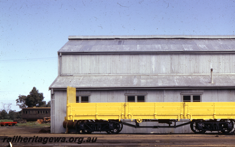 T05660
1 of 2 views of a WSG class standard gauge General Purpose wagon, all over yellow livery, incomplete side view
