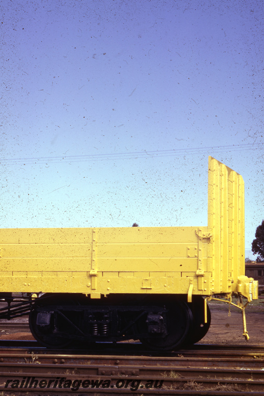T05661
1 of 2 views of a WSG class standard gauge General Purpose wagon, all over yellow livery, side view of the bogie and end bulkhead
