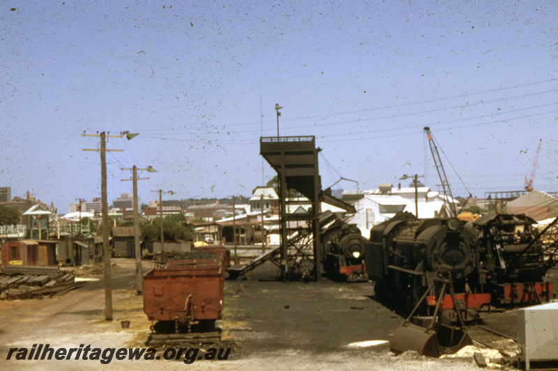 T05662
Steam locos, steam crane, wagons loaded with coal, coal stage , temporary loco depot, East Perth Loco depot, side on view of the depot
