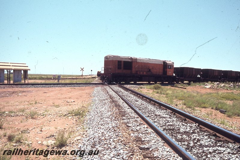 T05673
Goldsworthy Mining English Electric  A class locomotive No 4 hauling an iron ore train over the  Newgold Crossing near Port Hedland. 
