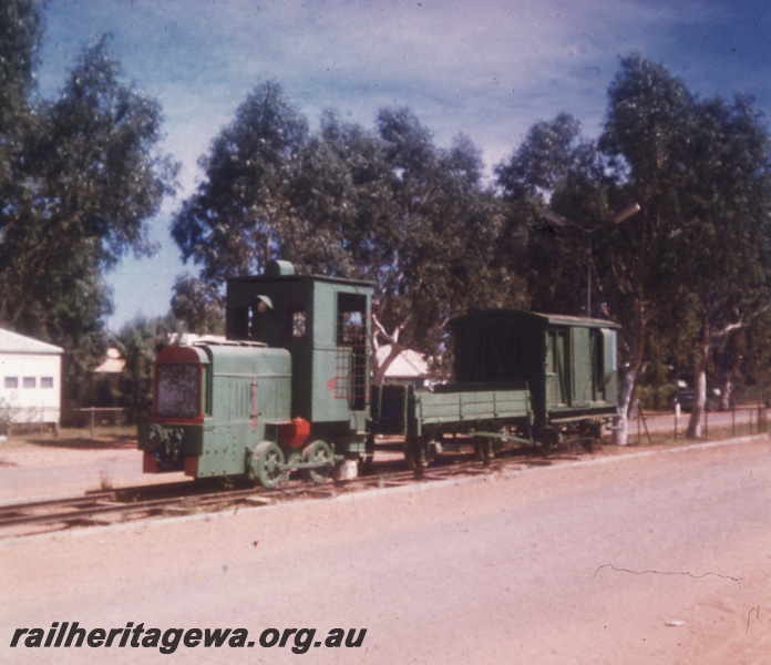 T05752
PWD Andrew Barclay diesel preserved in main street of Onslow. Wagon and brakevan attached to locomotive.
