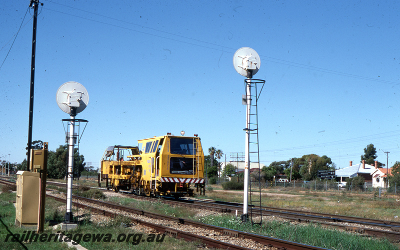 T05771
Track tamping machine, lineside cabinets, rear view of Searchlight signals, Merredin, EGR line, side and front view of the tamping machine
