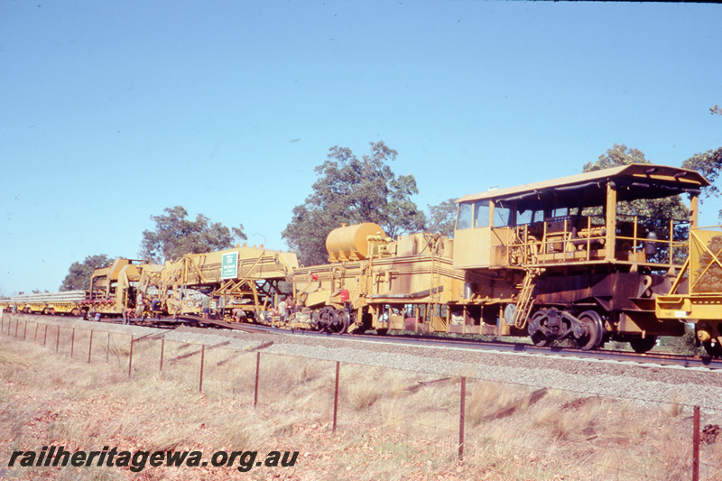 T05787
7 of 8 views of the work on the Kalgoorlie to Kwinana Rehabilitation Project featuring the P811 Track Replacement Machine. View along the train towards the wagons with the sleepers
