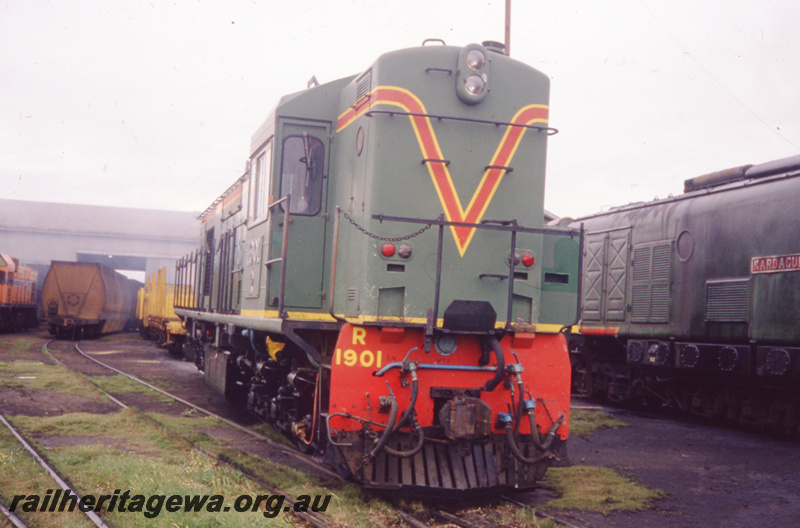 T05793
R class 1901 in the Green with red and yellow stripes livery, chain safety rails, mainly a front on view
