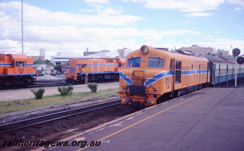 T05794
XA class 1402 on a suburban passenger train, AB class 1533 and another A type loco in the background, colour light signals, Claisebrook , 
