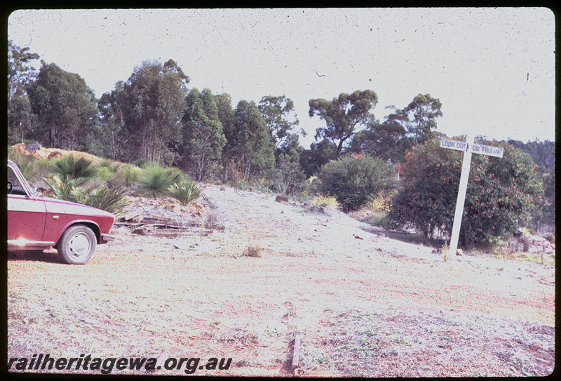 T06108
Old rail formation, level crossing, rails still in road, 