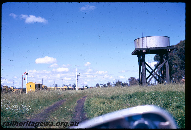 T06587
V Class 1209, goods train, arriving at Brunswick Junction, water tank, semaphore signals, Z Class brakevan in yellow livery
