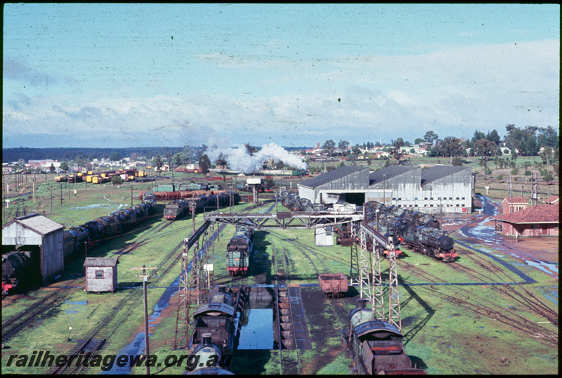 T06730
Collie loco depot, gantry crane, clamshell grab bucket, ash pit, roundhouse, turntable, stored steam locomotives, V Class 1220 departing Collie station with the ARHS 