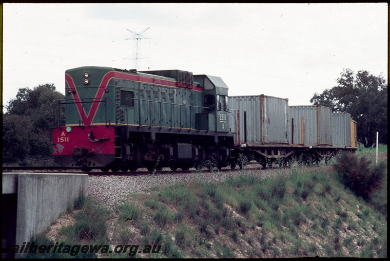 T07027
A Class 1511, Down goods train bound for Forrestfield, QUA Class flat wagons, approaching Helena River, concrete bridge, western leg of Woodbridge Triangle, West Midland
