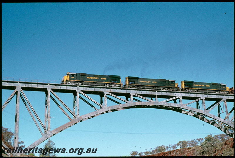 T07306
Hamersley Iron ALCos M636 4051, 4035 and 4039, loaded iron ore train, Spring Creek Bridge, steel arch bridge, Pilbara
