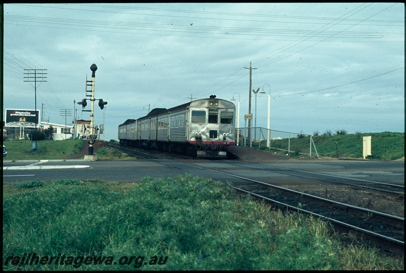 T07414
ADB Class 771 with ADK/ADB/ADK Class railcar set, Down suburban passenger service, Victoria Street, station nameboard, platform, shelter, level crossing, ER line
