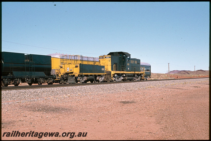 T07489
Hamersley Iron ALCo C415 1000 with brake tender, Pilbara Railway Historical Society tour train in background, PWT Class 1 auxillary tender, ex-NSWGR FS Class carriages in background, Dingo, Pilbara
