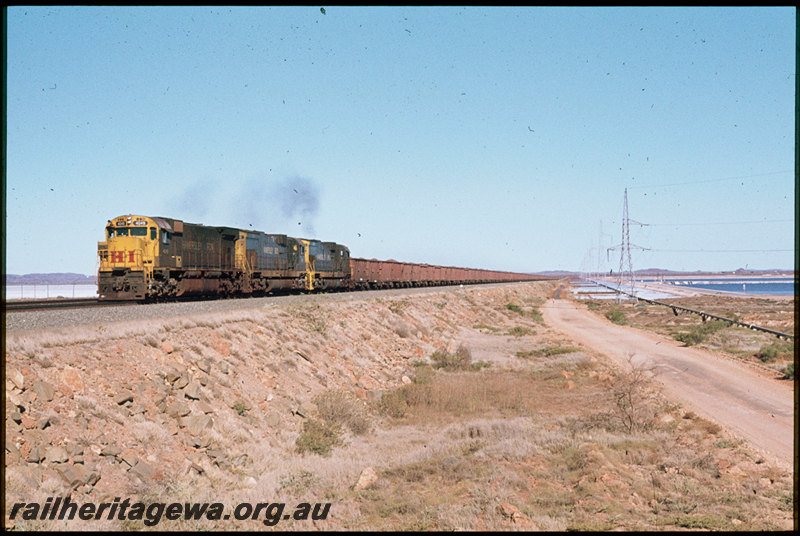 T07501
Hamersley Iron ALCos M636 4049 with two C636 locos, loaded iron ore train, causeway, Dampier, Pilbara
