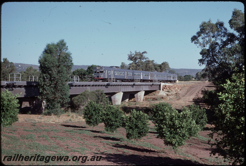 T08402
ADK/ADB/ADK/ADB Class railcar set, Up suburban passenger service, Canning River Bridge, steel girder, concrete pylon, between Gosnells and Stokley, SWR line
