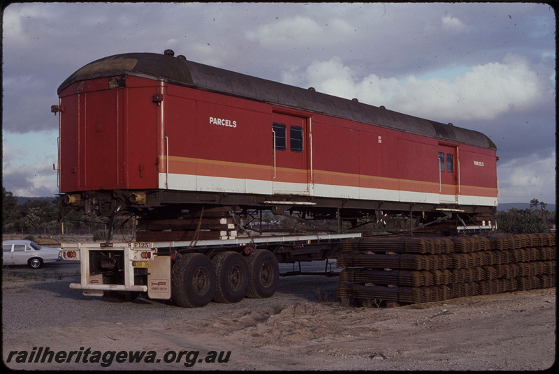 T08428
Ex-NSWGR KBY Class 2513 parcels van, candy livery, without bogies, loaded on flatbed truck trailer at Forrestfield for transport to the Pilbara Railways Historical Society in Dampier
