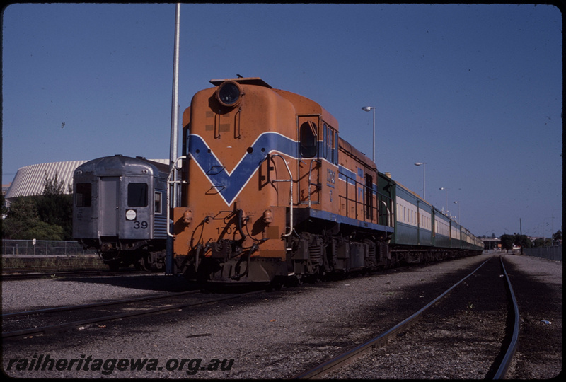 T08482
C Class 1702, stabled in carriage sidings, Perth Yard, 5-car set of hired Queensland Railways (QR) SXV and SX Class carriages, ER line
