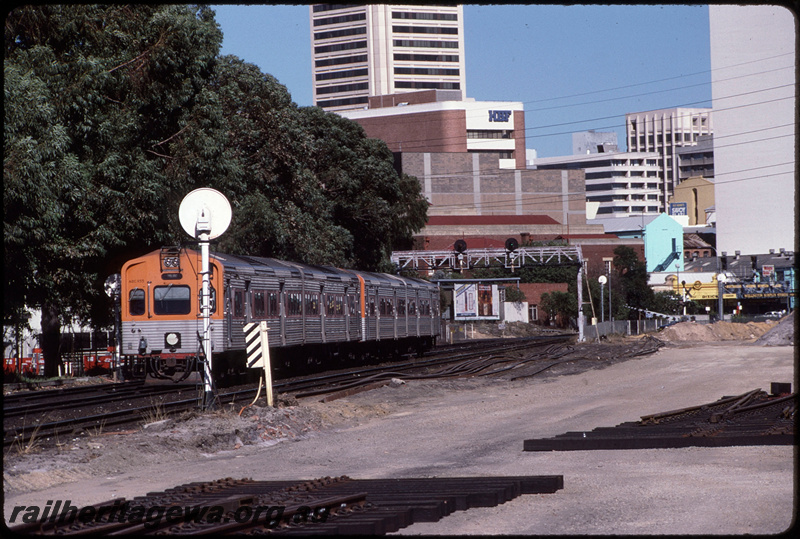 T08636
ADC Class 855 with ADL/ADC/ADL Class railcar set, Up suburban passenger service, between Claisebrook and City Station, searchlight signal gantry, Moore Street level crossing, earthworks underway for construction of additional trackwork and McIver Station, ER line
